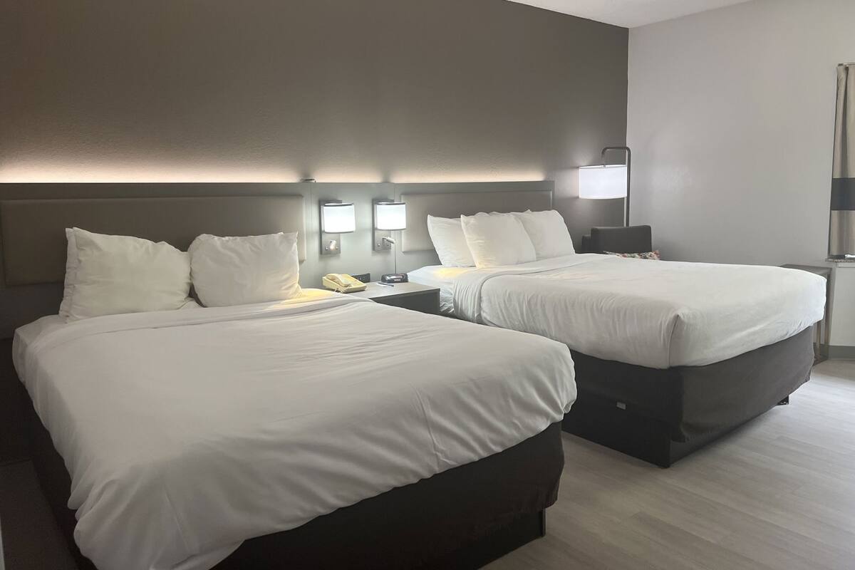 Hypo-allergenic bedding, desk, laptop workspace, blackout drapes