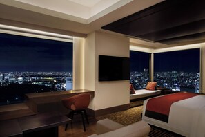 A hotel room with a city view, a flat-screen TV, a sofa, a bed, and a desk. - The Prince Gallery Tokyo Kioicho, a Luxury Collection Hotel (Tokyo)