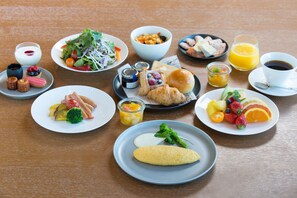 A variety of breakfast dishes including eggs, fruits, and pastries on a wooden table. - The Prince Gallery Tokyo Kioicho, a Luxury Collection Hotel (Tokyo)