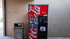 A Coca-Cola vending machine with multiple beverage options and a coin slot. - Red Roof Inn Petersburg - Fort Lee (Petersburg)