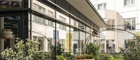 An outdoor seating area with modern furniture and potted plants.