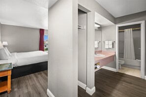 Suite, 1 King Bed, Kitchenette | Desk, laptop workspace, blackout drapes, iron/ironing board
