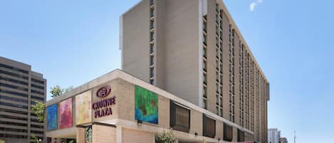 A multi-story hotel with a prominent sign for Crown Plaza.