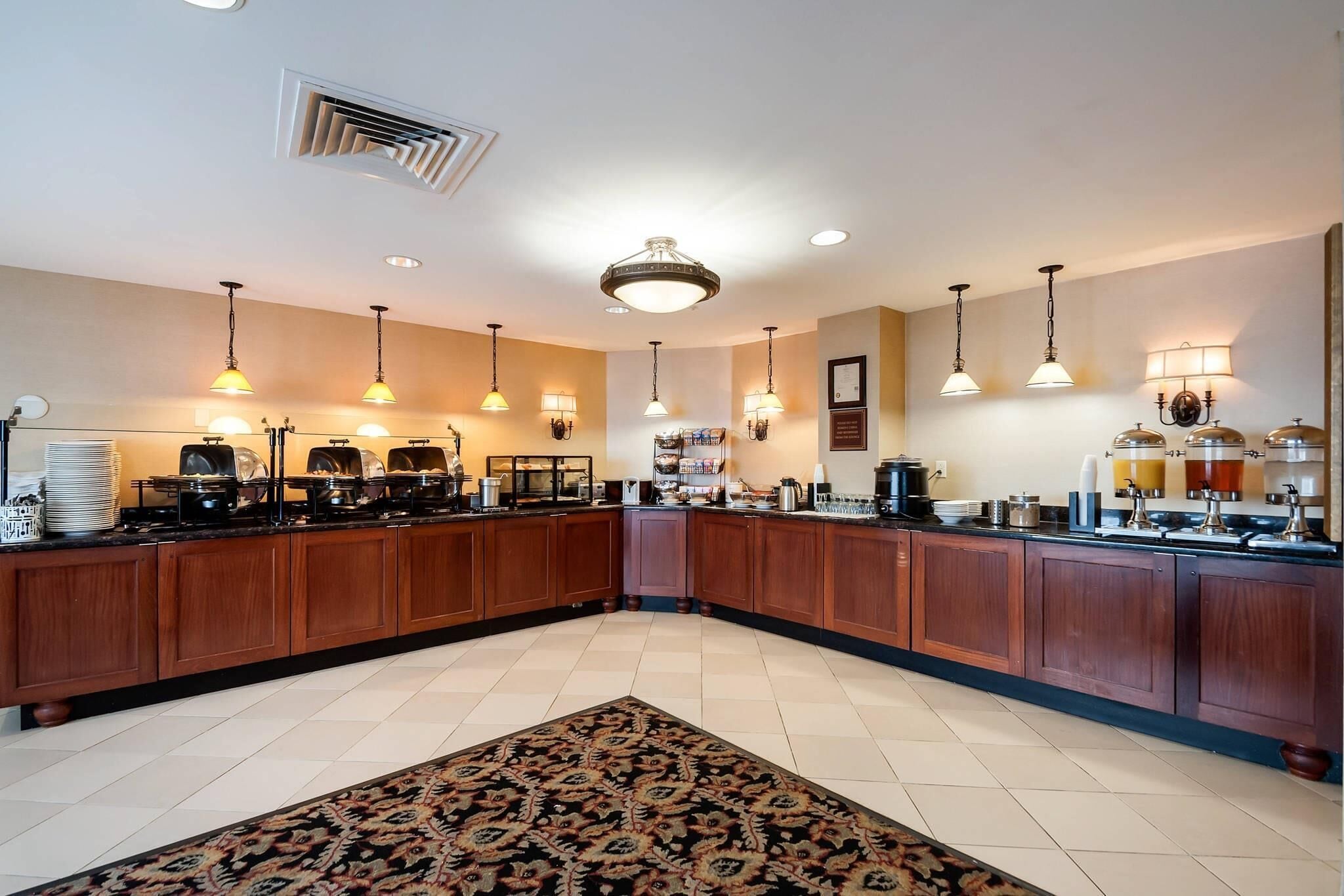 A spacious kitchen with wooden cabinets, a central island, and various cooking appliances.