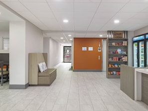A hotel lobby with a seating area, a refreshment bar, and a view of the outside. - Sleep Inn Chambersburg (Chambersburg)