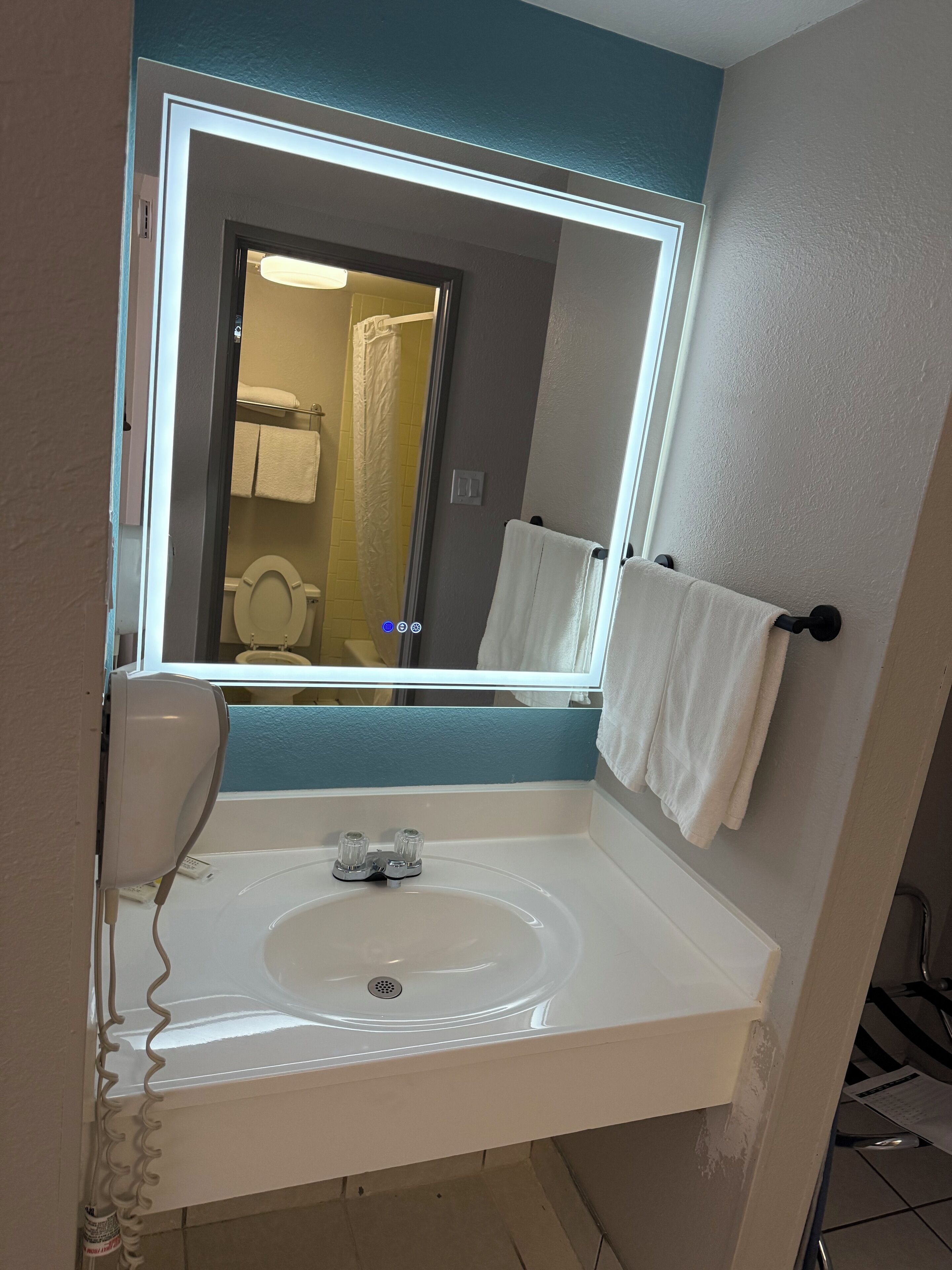 Bathtub, eco-friendly toiletries, hair dryer, towels