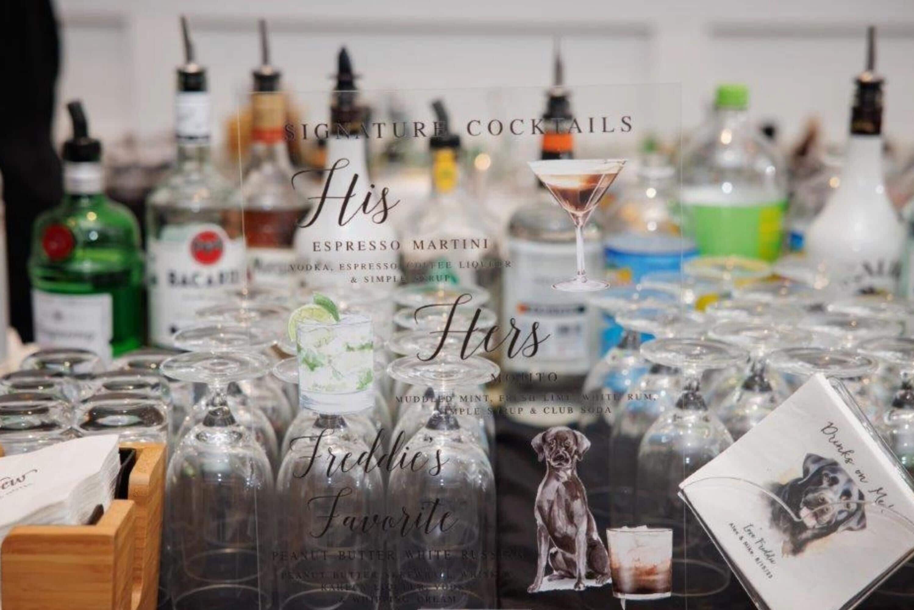 A variety of liquor bottles and glasses, with labels indicating different types of drinks.