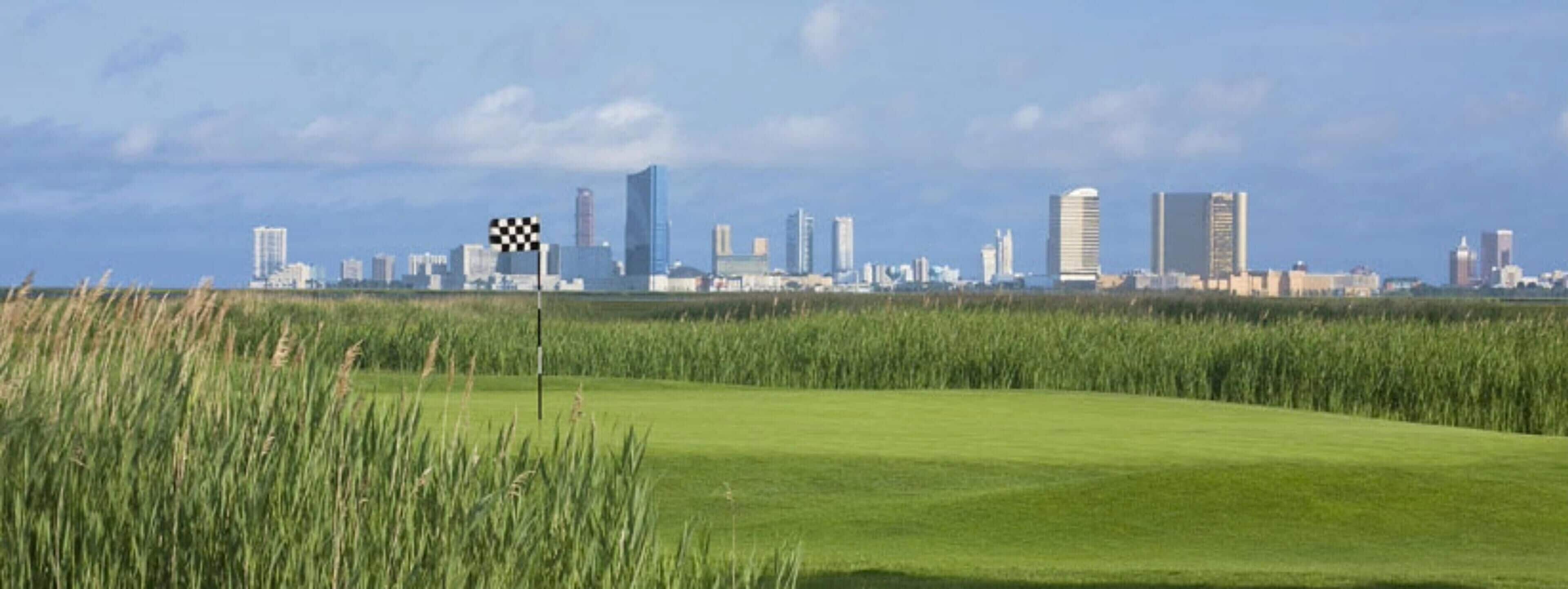A city skyline with modern buildings and a checkered flag in the foreground.