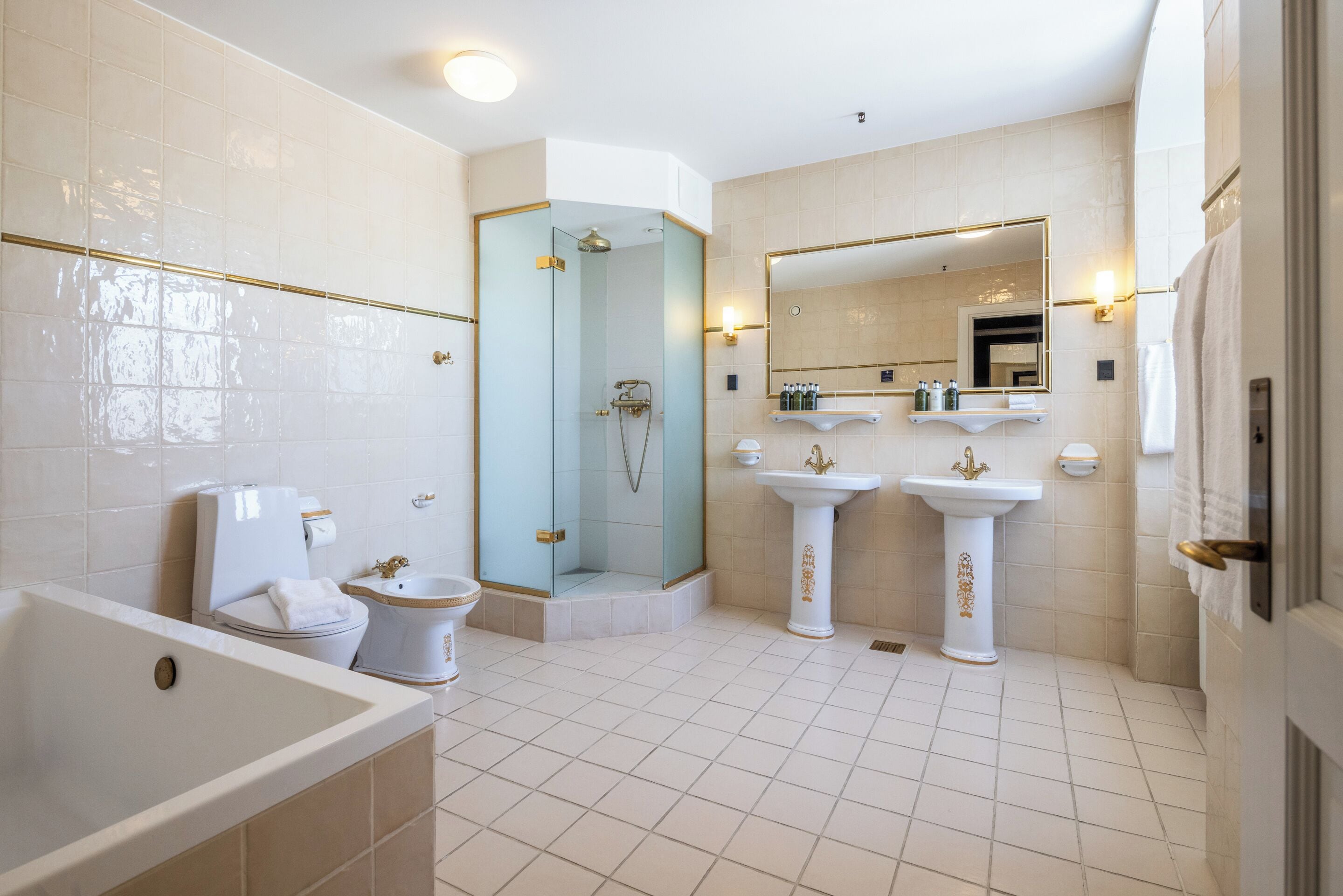 king's suite | bathroom | designer toiletries, hair dryer, bathrobes, heated floors