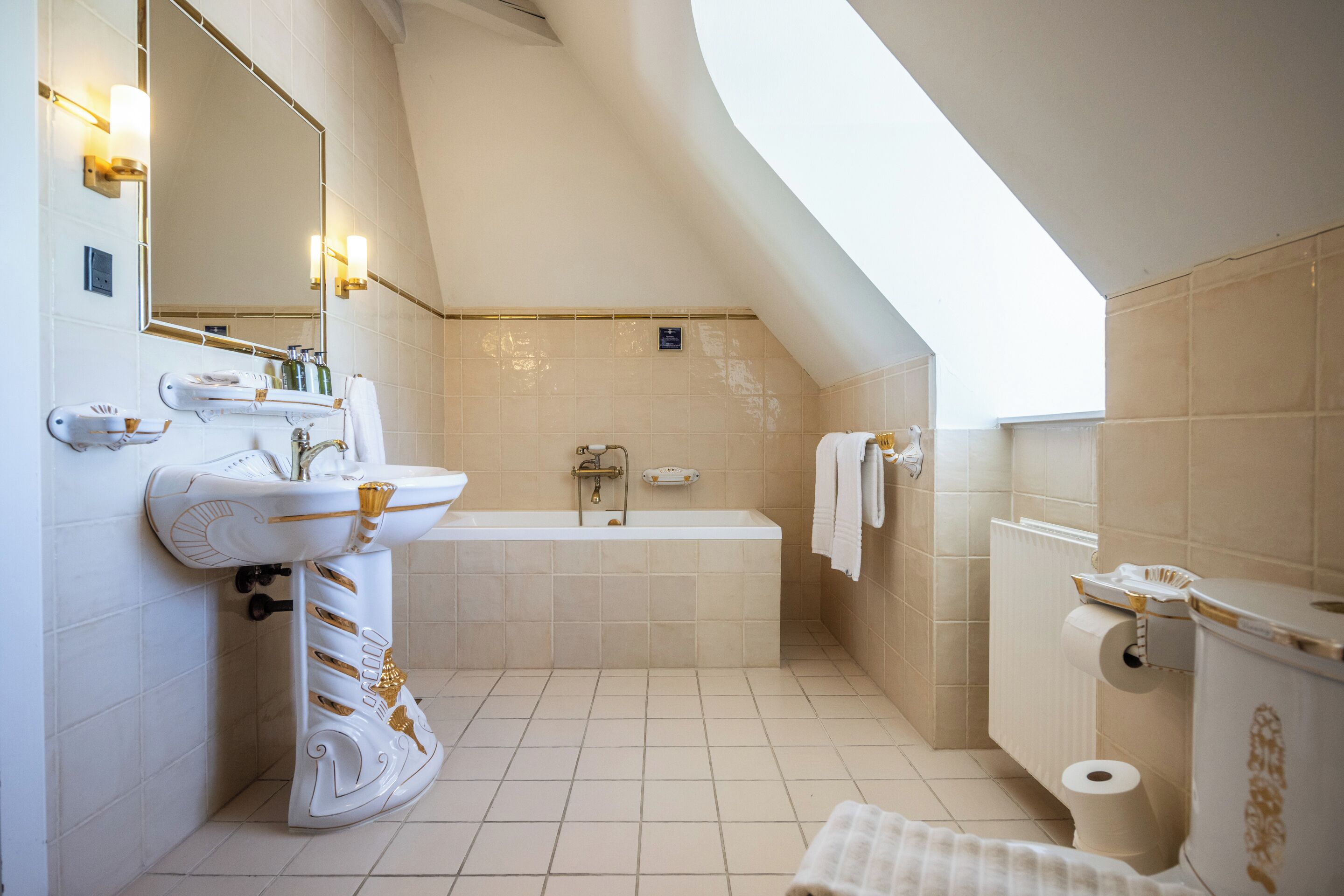 A modern bathroom with a bathtub, a sink, and a toilet.