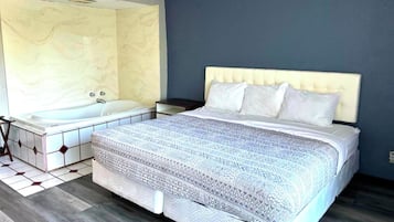 Suite, 1 King Bed, Non Smoking (Jacuzzi Tub) | Iron/ironing board, WiFi (free), bed sheets