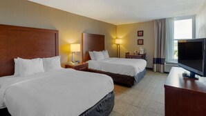 A hotel room with two beds, a TV, a desk, and a window with curtains. - Comfort Inn Blacksburg University Area (Christiansburg)