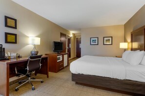 A hotel room with a bed, desk, chair, television, and two framed pictures on the wall. - Comfort Inn Blacksburg University Area (Christiansburg)