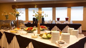 A buffet setup with various food items and drinks, arranged on a table with a black and white tablecloth. - Wedgewood Resort (Fairbanks)