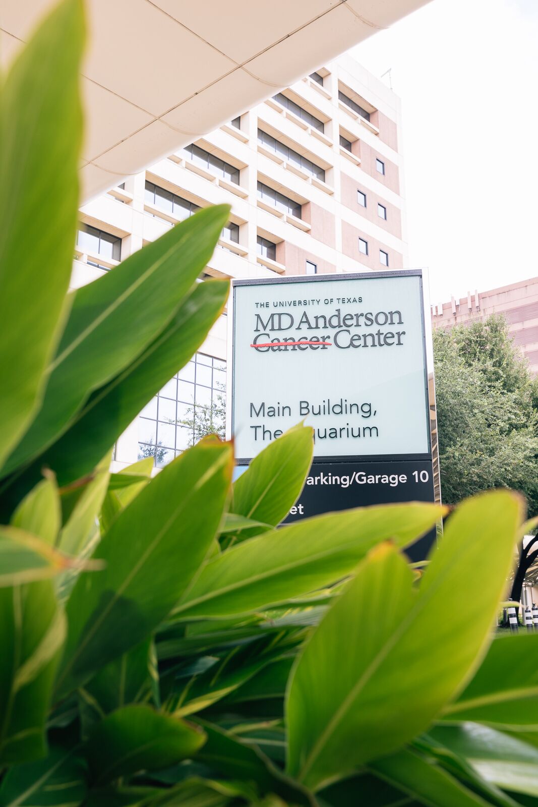 A sign for the MD Anderson Cancer Center, indicating the main building and parking garage location.
