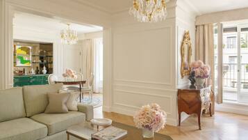 A spacious living room with a sofa, coffee table, and a chandelier.
