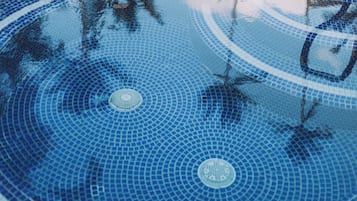 A circular pattern of blue tiles with a central circular design.