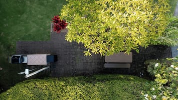 A rooftop garden with a seating area, a fire pit, and a view of the surrounding landscape.