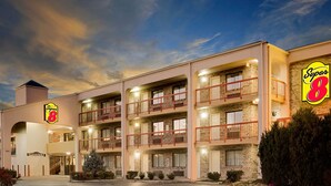 A Super 8 hotel with a brick facade, multiple balconies, and an entrance with an elevator. - Super 8 by Wyndham Hermitage Nashville (Hermitage)