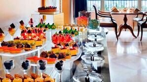 A buffet with various desserts and beverages on display.