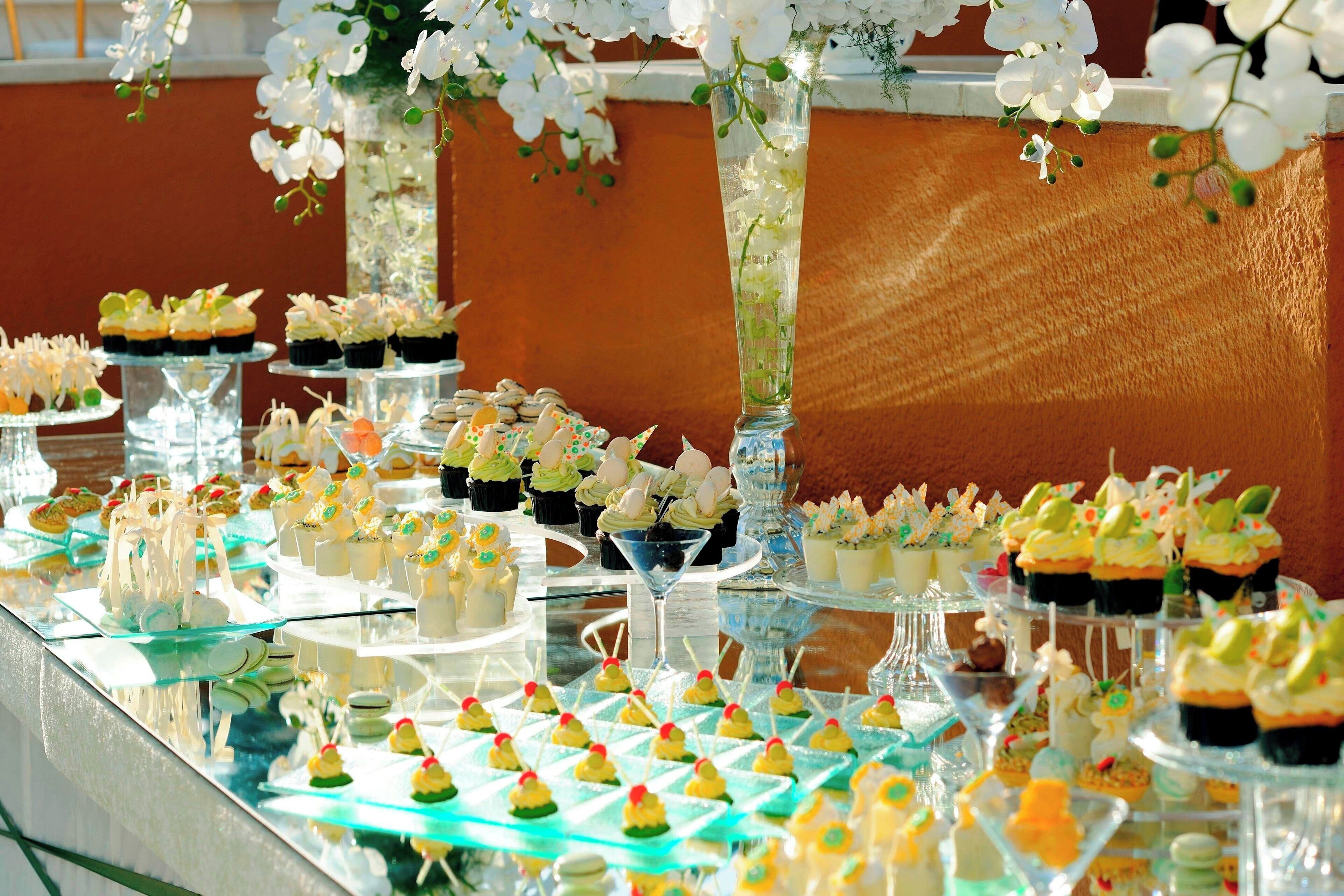 A buffet table with various desserts and snacks.