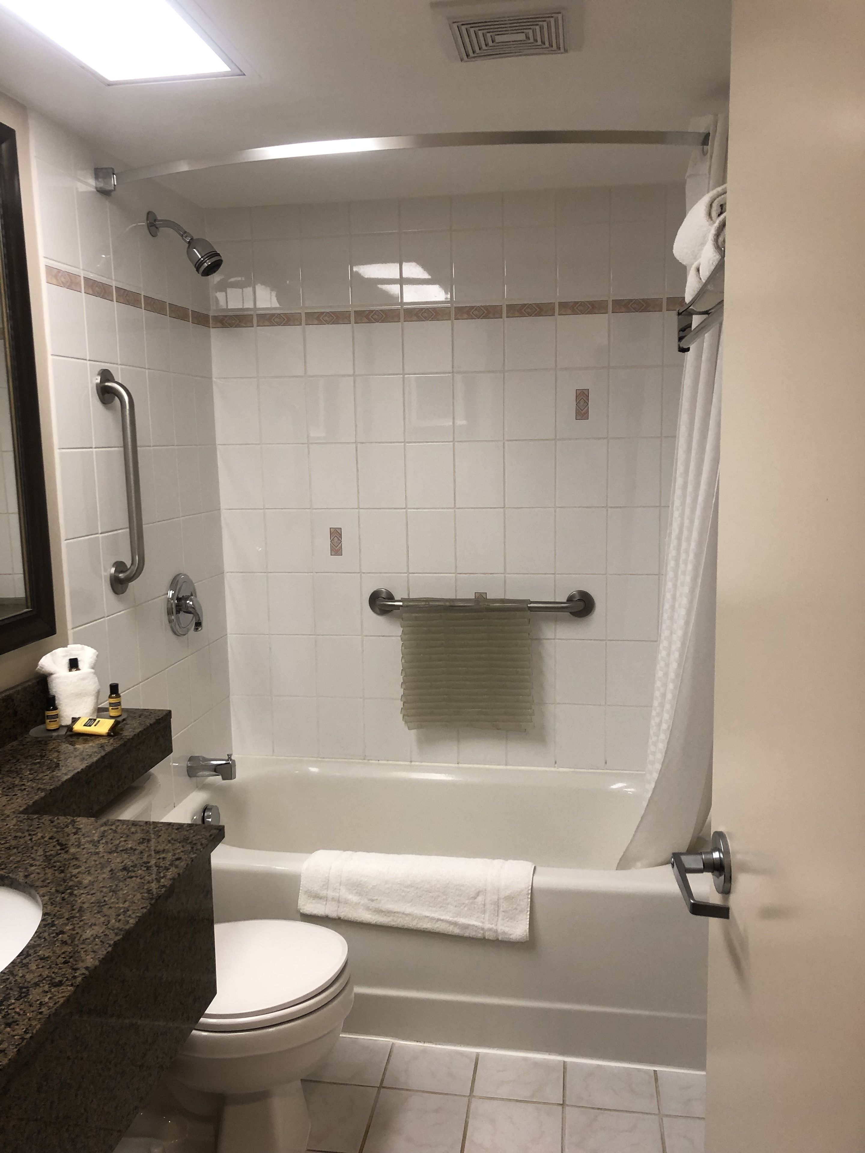 A bathroom with a toilet, sink, and bathtub.