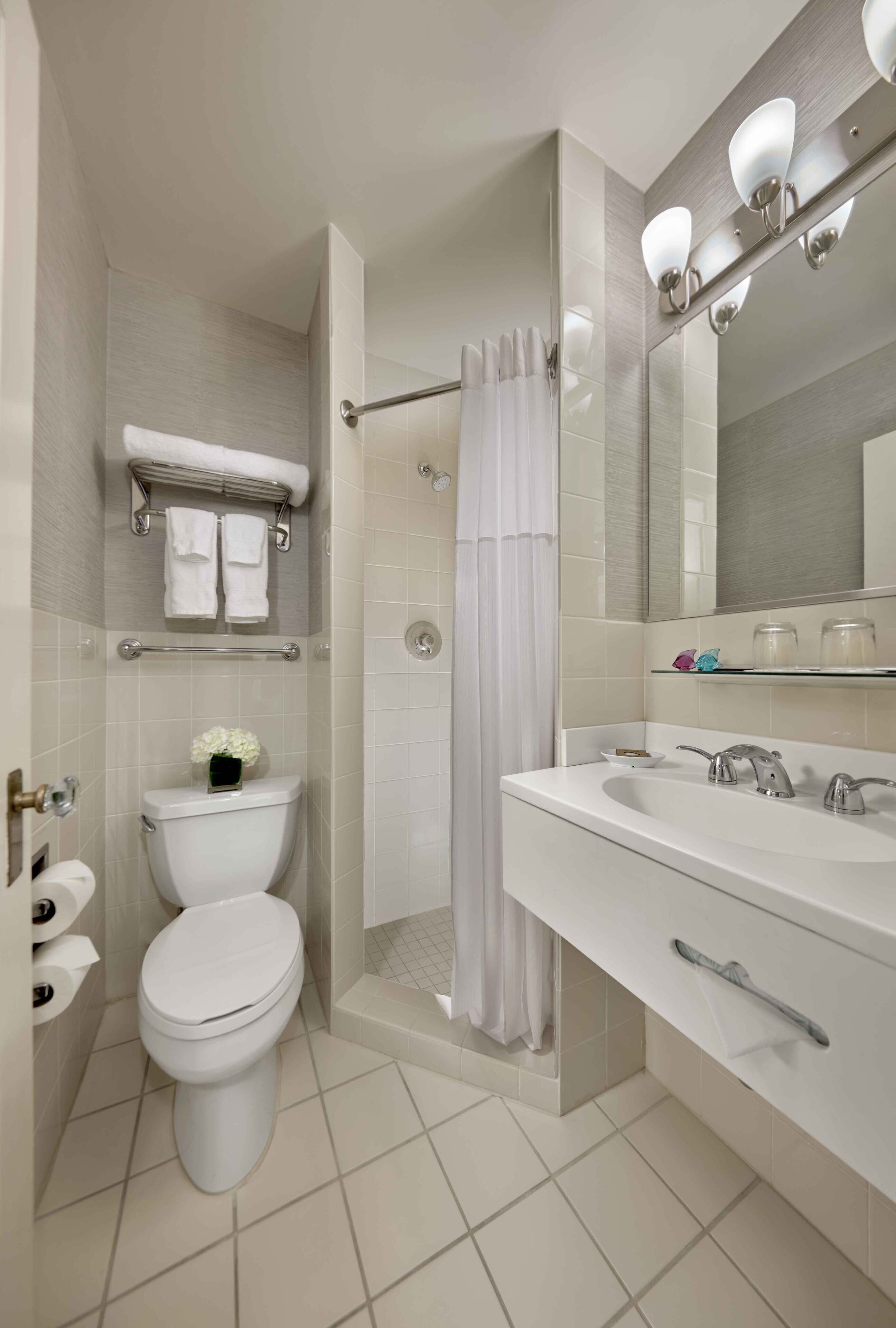 combined shower/bathtub, designer toiletries, hair dryer, towels