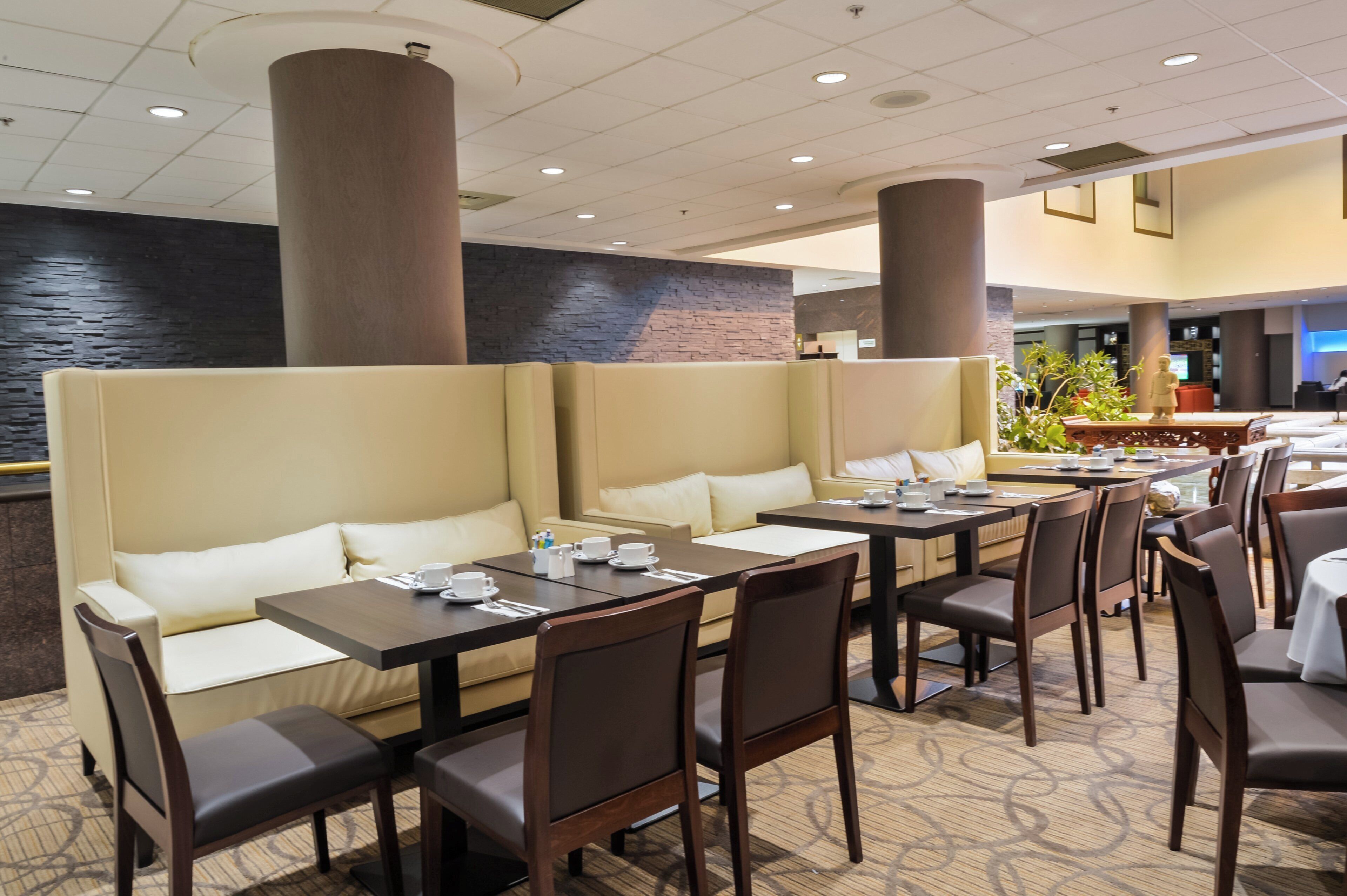 A restaurant with booth seating, tables, and chairs.