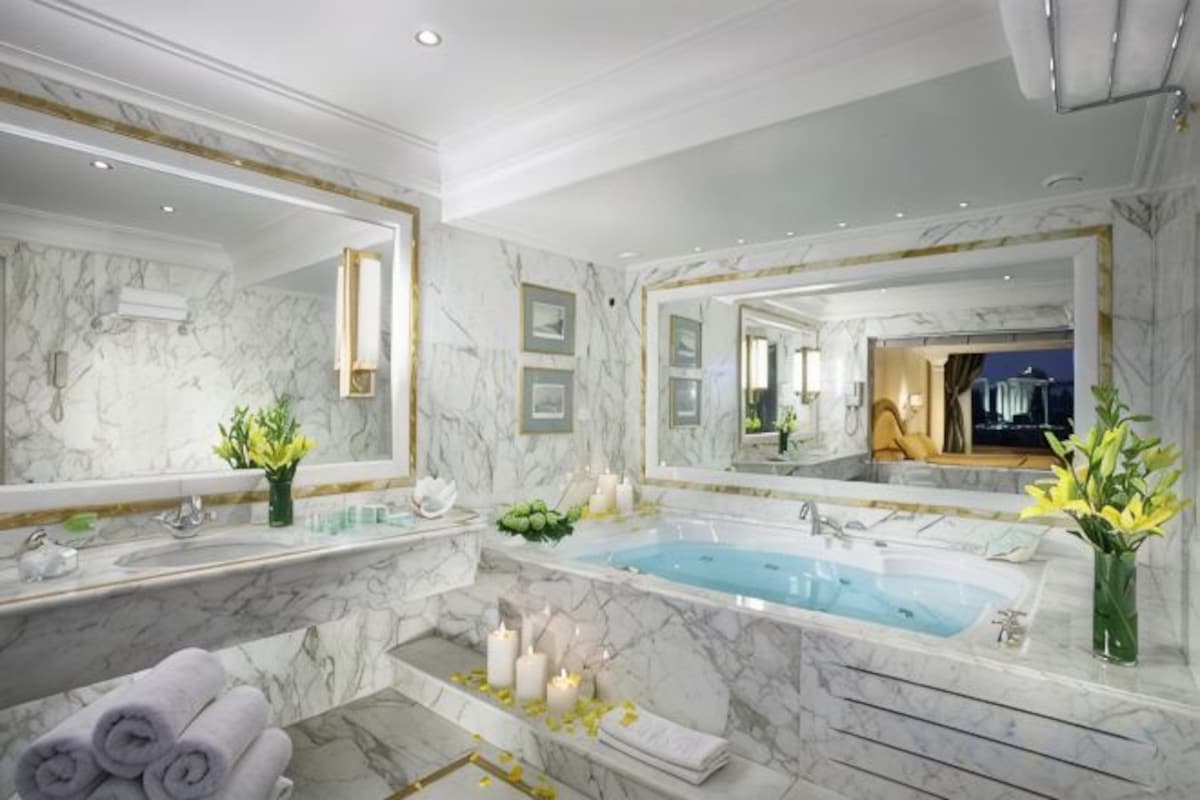 Bathtub, designer toiletries, hair dryer, towels