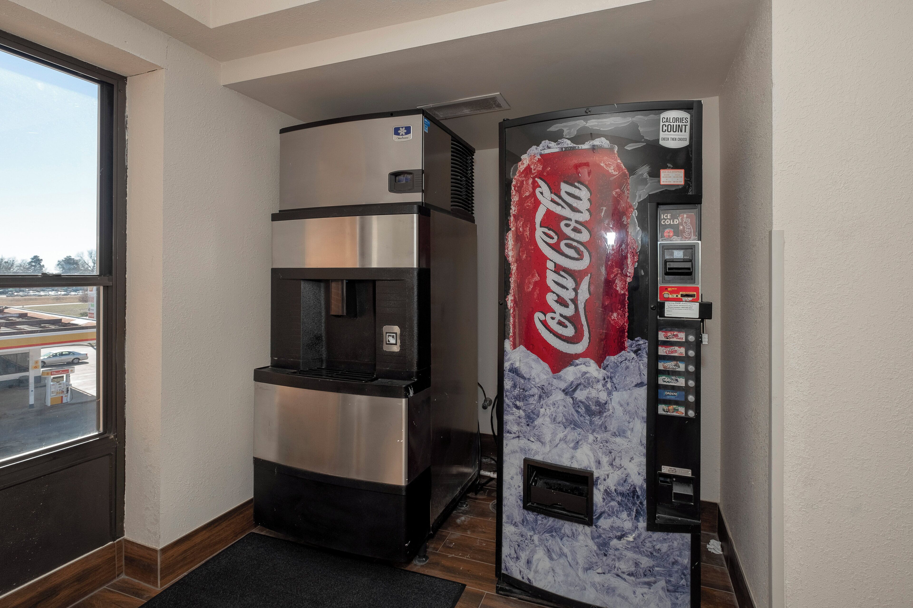 A vending machine with a Coca-Cola logo and a water dispenser.