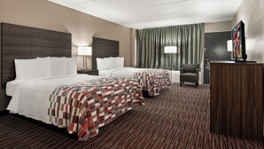 A hotel room with two beds, a desk, a chair, a television, and a large window with curtains. - Red Roof Inn Reading (Reading)