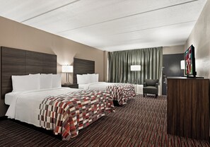 A hotel room with two beds, a desk, a chair, a television, and a large window with curtains. - Red Roof Inn Reading (Reading)