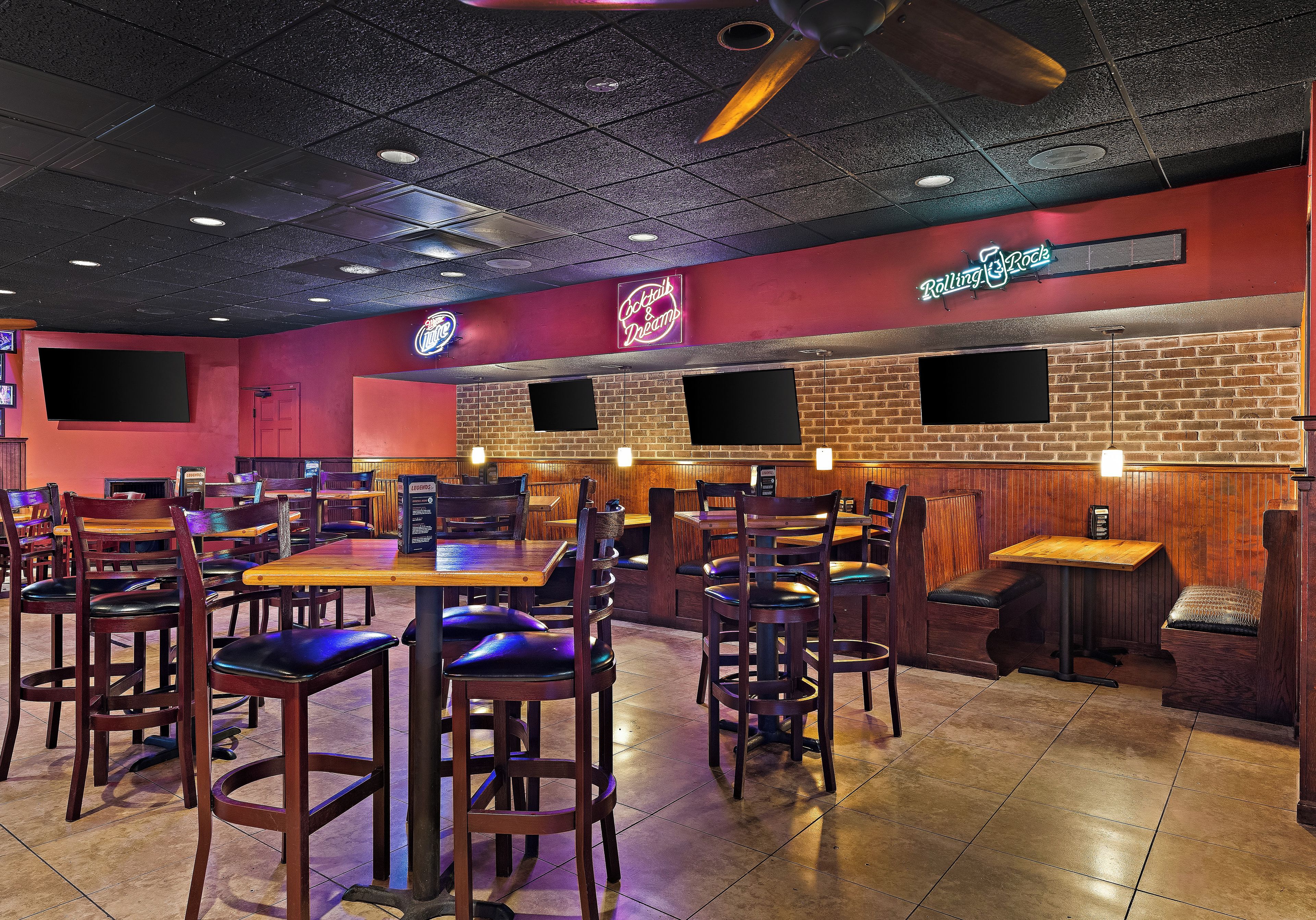 A restaurant interior with booths, tables, and chairs.