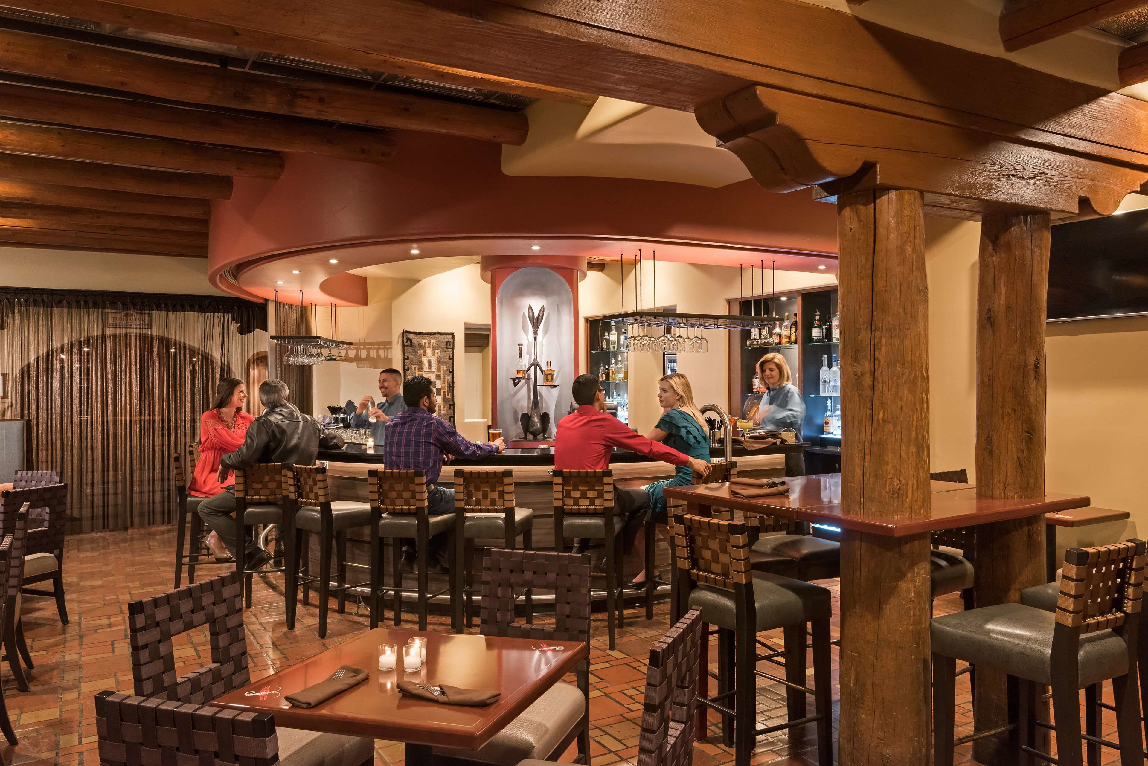 A restaurant with wooden furniture and a bar area.