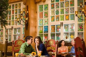 A dining area with colorful tile walls and wooden furniture. - La Fonda on the Plaza (Santa Fe)
