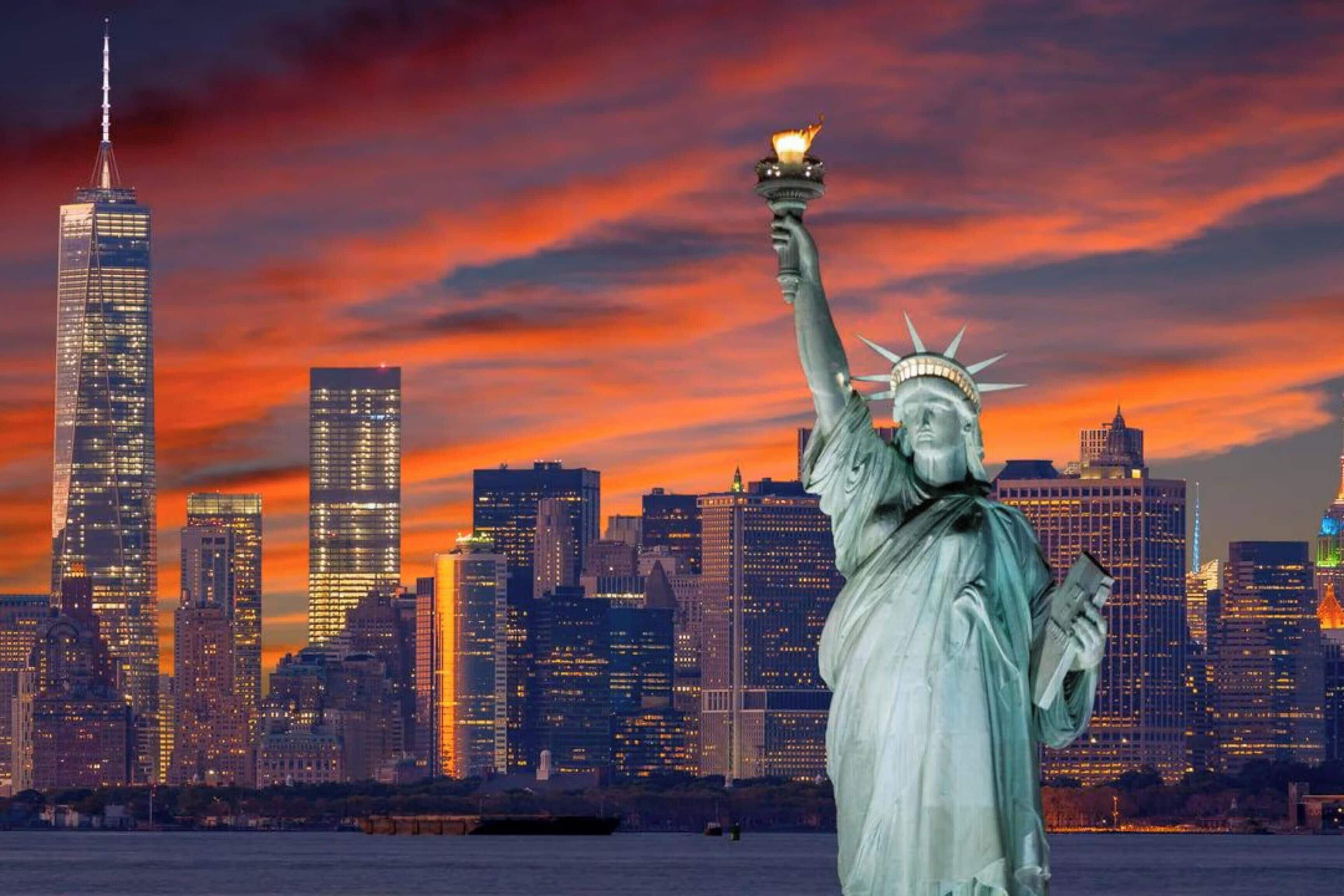 The Statue of Liberty with a city skyline in the background.