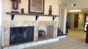 A fireplace with a mantel shelf, a framed artwork, and a decorative vase. - Days Inn by Wyndham Santa Fe New Mexico (Santa Fe)