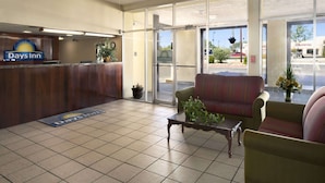 A reception area with a reception desk, a coffee table, and two sofas. - Days Inn by Wyndham Santa Fe New Mexico (Santa Fe)