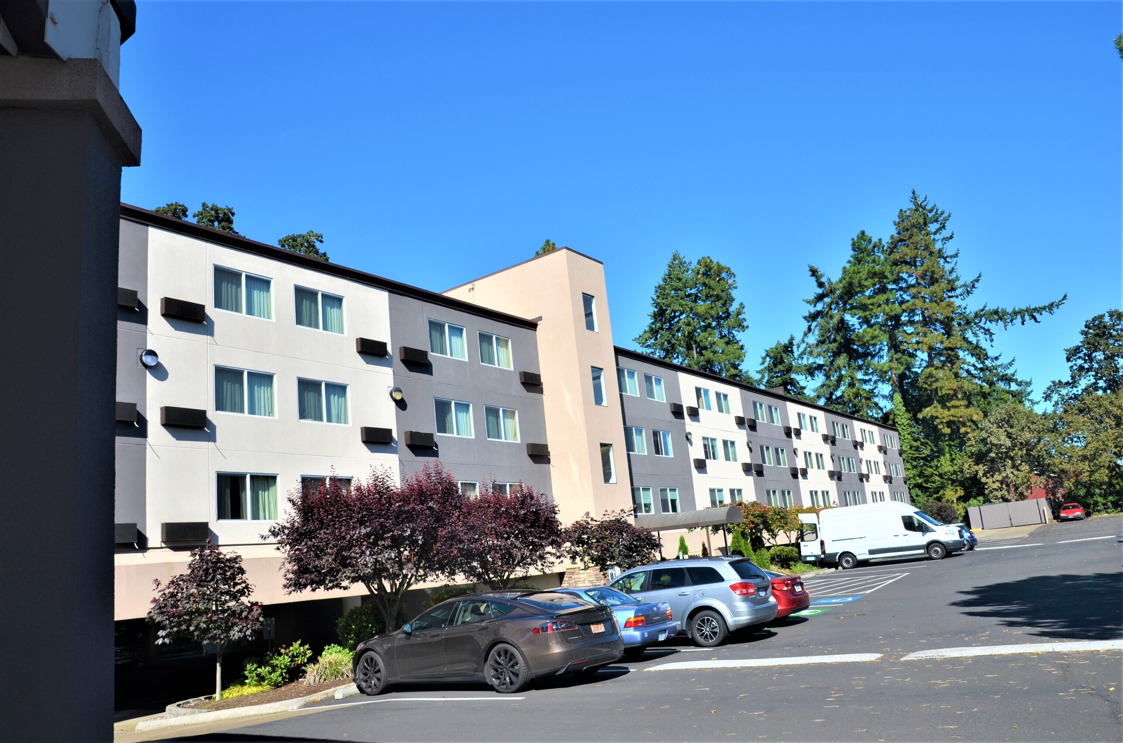 A multi-story residential building with a parking lot.