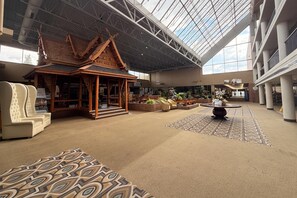 A spacious lobby with a traditional wooden structure, seating areas, and a patterned carpet. - Medicine Hat Lodge (Medicine Hat)
