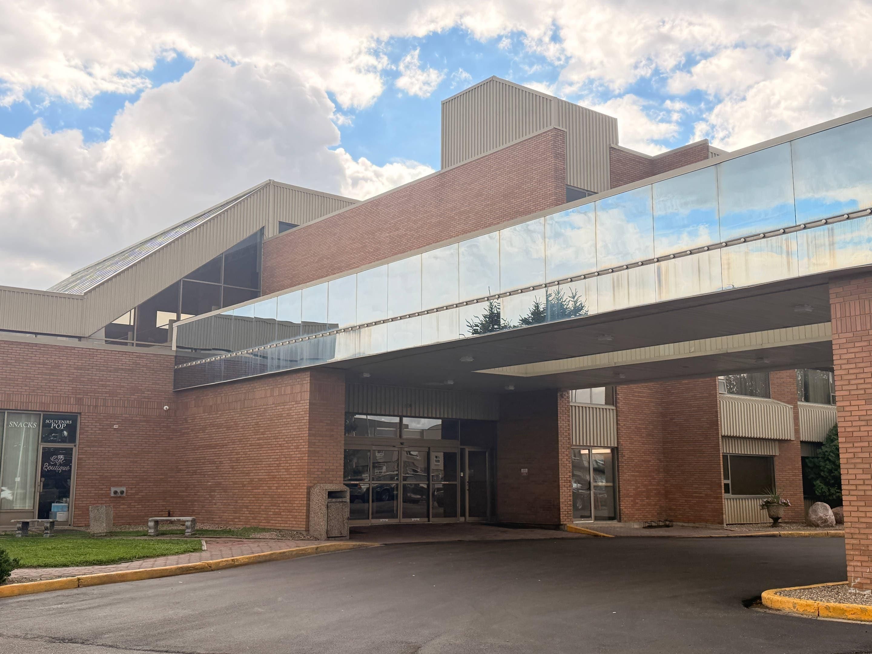 A modern building with a glass entrance and a brick facade.