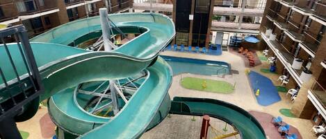 A multi-level indoor water park with slides and pools.