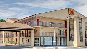 A Super 8 motel with a two-story structure, multiple balconies, and a covered parking area.