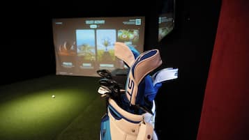 A golf bag with a logo, placed in front of a screen displaying various golf-related activities.