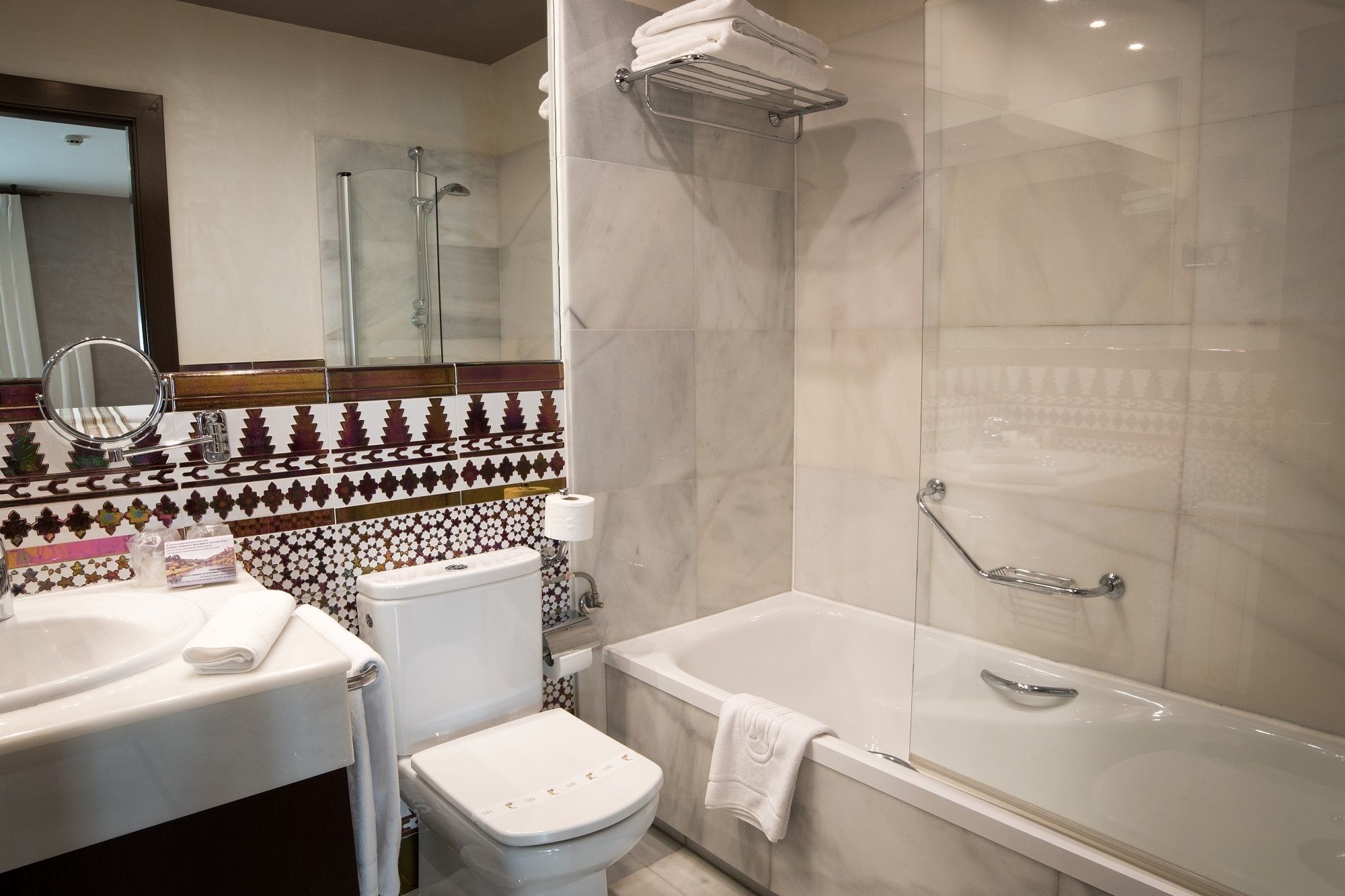 A bathroom with a toilet, sink, and bathtub.