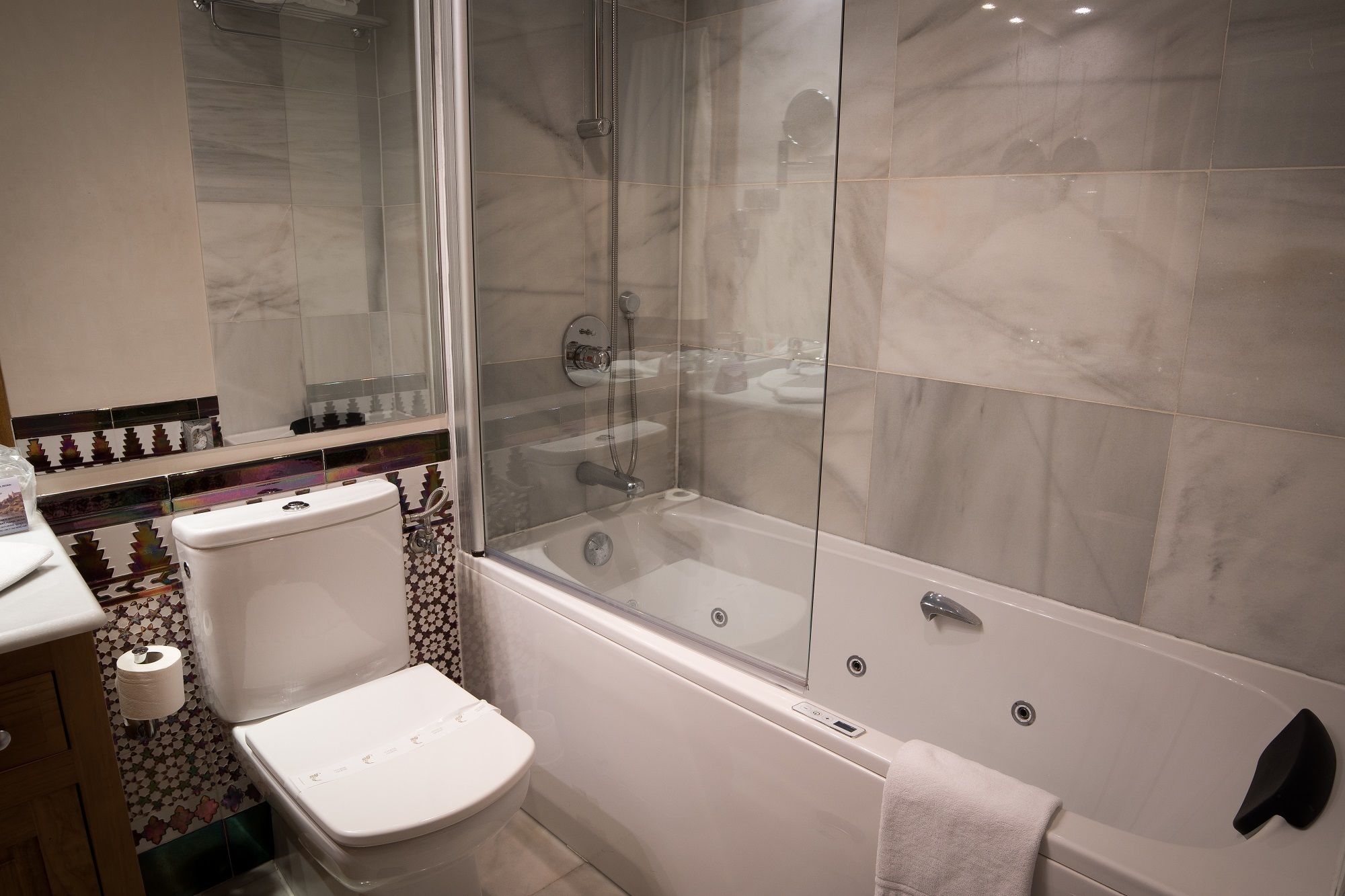 A bathroom with a toilet, a shower enclosure, and a bathtub.