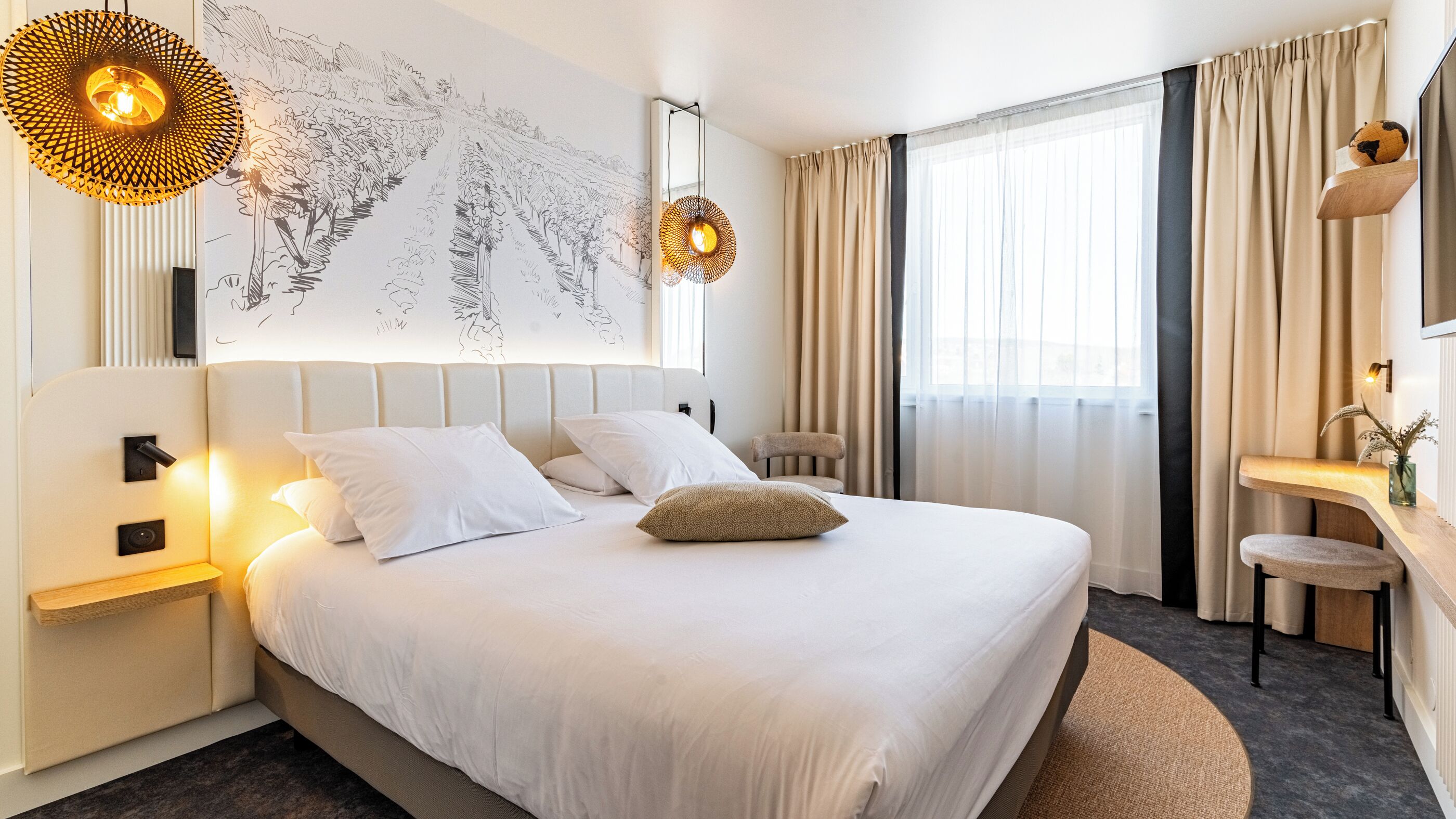 A modern hotel room with a large bed, a desk, and a chair. There is a large window with curtains, a wall-mounted TV, and a map artwork.