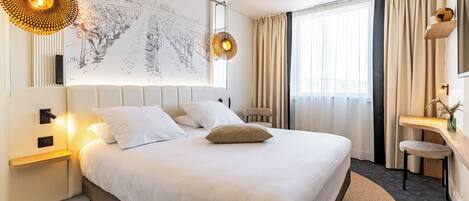 A modern hotel room with a large bed, a desk, and a chair. There is a large window with curtains, a wall-mounted TV, and a map artwork.