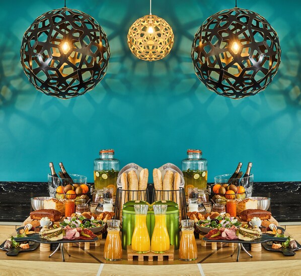 A breakfast buffet with a variety of foods and drinks, including pastries, sandwiches, and juice. - Mercure Beaune Centre (Beaune)