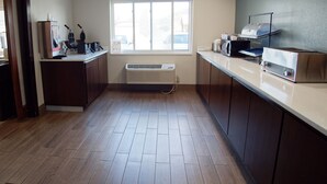 A kitchen with wooden flooring, a window, and a built-in microwave. - Country Inn & Suites by Radisson, Coeur d'Alene (Coeur d'Alene)